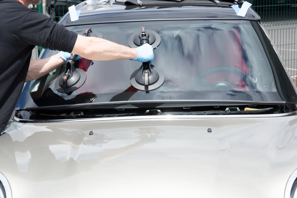 Mobile Glass Repair Technician Removing Windshield On A Car