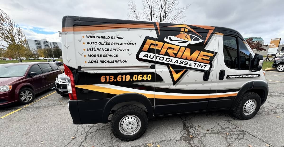 a sleek urban auto glass repair van emphasizing the contrast between mobile auto glass repair and in-shop services.