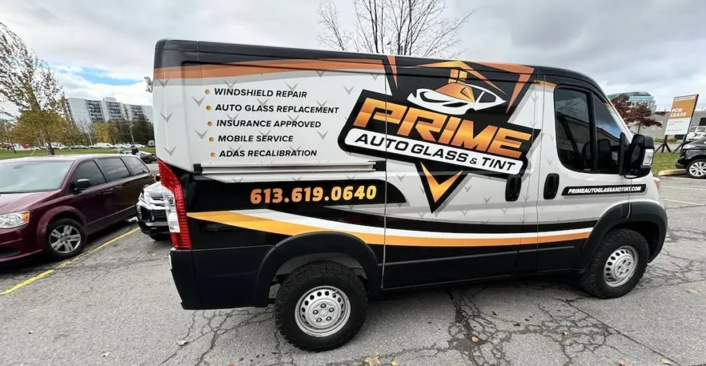 Mobile windshield repair technician servicing a vehicle at a customer's home, showcasing convenience and customer satisfaction